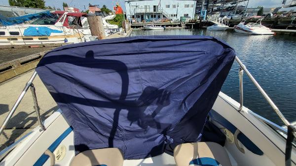 Slide: The Image of 1996 Four Winns 190 Horizon Bowrider at a marina, covered with a blue tarp. - 25