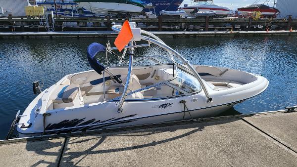 Slide: The Image of 1996 Four Winns 190 Horizon Bowrider docked at a marina. - 4