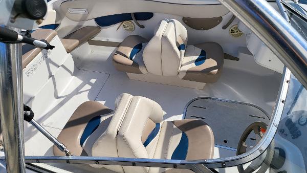 Slide: The Image of 1996 Four Winns 190 Horizon Bowrider interior with beige and blue seating. - 7