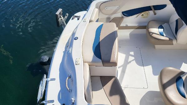 Slide: The Image of 1996 Four Winns 190 Horizon Bowrider interior, white and blue seating, docked on water. - 8