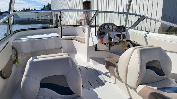 Slide: The Image of 1996 Four Winns 190 Horizon Bowrider interior with steering console and seating. - 9
