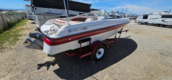 Slide: The Image of 1996 Four Winns 190 Horizon DLX boat on a trailer in a parking lot. - 3