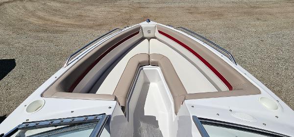 Slide: The Image of 1996 Four Winns 190 Horizon DLX bow seating area with beige and red upholstery. - 7