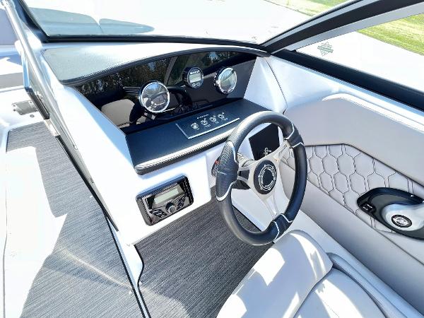 Slide: The Image of 2023 Four Winns H1 OB boat dashboard with steering wheel and control panel. - 19