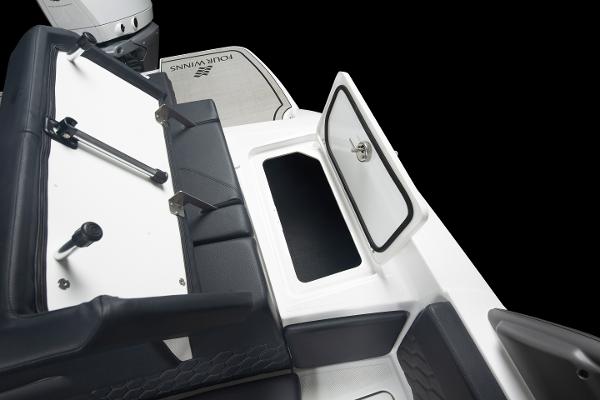 Slide: The Image of 2023 Four Winns H2 OB boat interior with storage compartment and seating. - 21