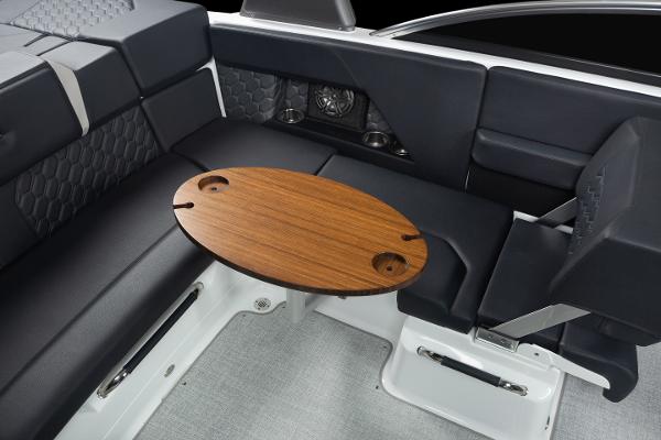 Slide: The Image of 2023 Four Winns H2 OB boat interior with black seating and wooden table. - 27