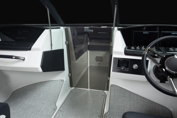 Slide: The Image of 2023 Four Winns H2 OB boat interior, helm station and cabin entrance. - 33