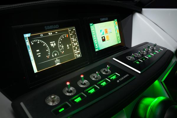 Slide: The Image of 2023 Four Winns H2 OB boat dashboard with Simrad displays and illuminated controls. - 8