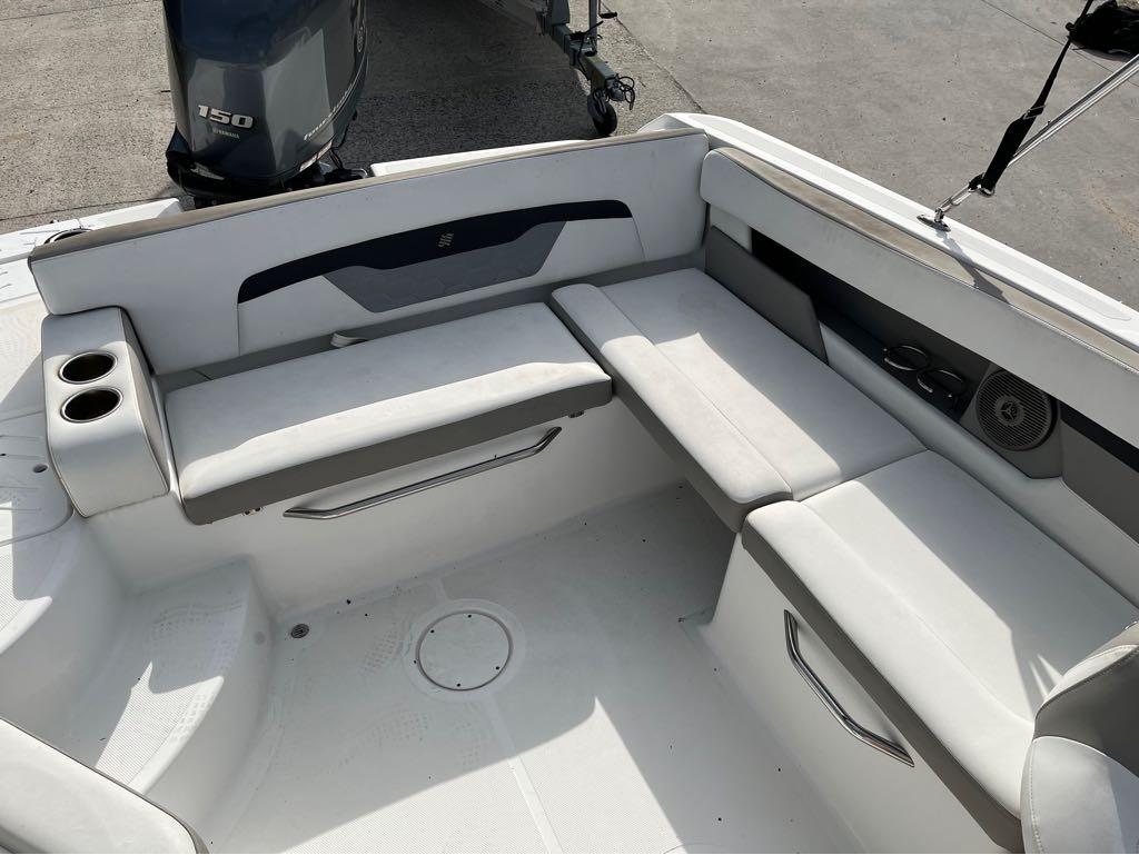 Slide: The Image of 2020 Four Winns HD 200 OB boat interior with cushioned seating and cup holders. - 10