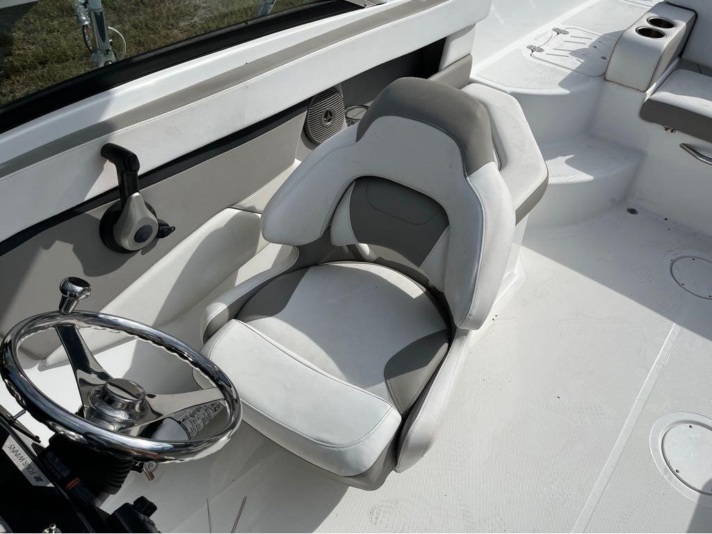 Slide: The Image of Captain's seat and steering wheel of a 2020 Four Winns HD 200 OB boat. - 11