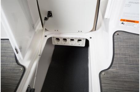 Slide: The Image of 2020 Four Winns HD 200 OB storage compartment with black mat and white interior. - 21