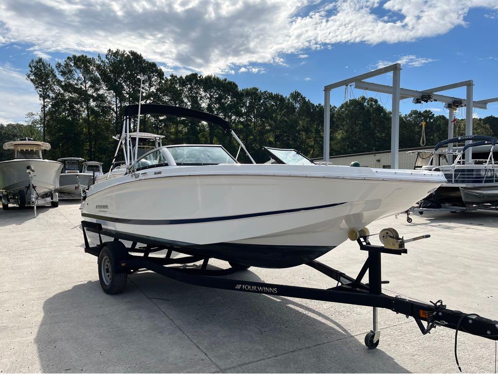 Slide: The Image of 2020 Four Winns HD 200 OB boat on trailer in marina. - 31