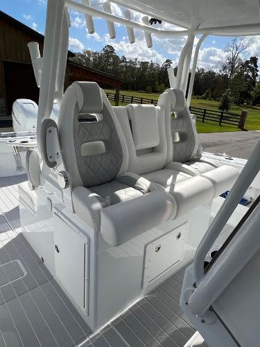 Slide: The Image of 2022 Freeman 37 VH boat with luxurious white seating and storage compartments. - 12