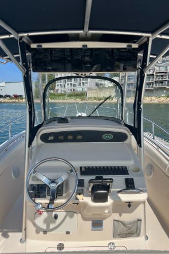 Slide: The Image of 2005 Grady-White 283 RELEASE boat cockpit with steering wheel and controls. - 11