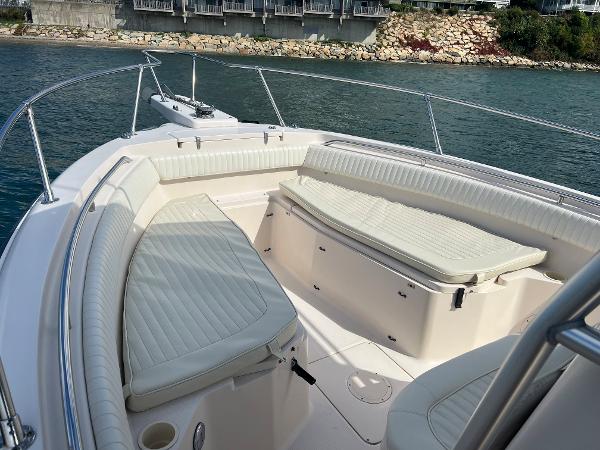 Slide: The Image of 2005 Grady-White 283 RELEASE boat with spacious seating, docked near rocky shoreline. - 14