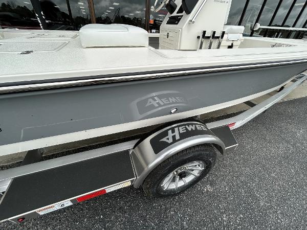 Slide: The Image of 2024 Hewes Redfisher 18 boat on trailer, side view, gray hull, outdoor display. - 13