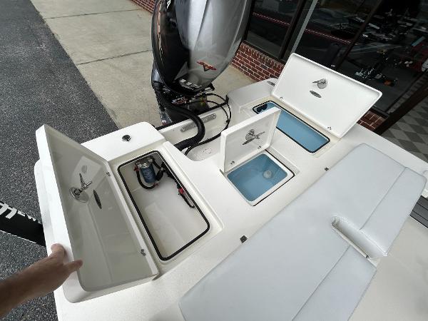 Slide: The Image of 2024 Hewes Redfisher 18 boat storage compartments and engine. - 20