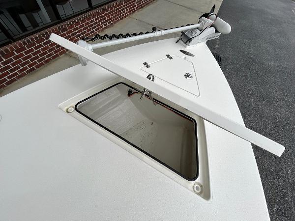 Slide: The Image of 2024 Hewes Redfisher 18 boat with open storage compartment and trolling motor. - 24