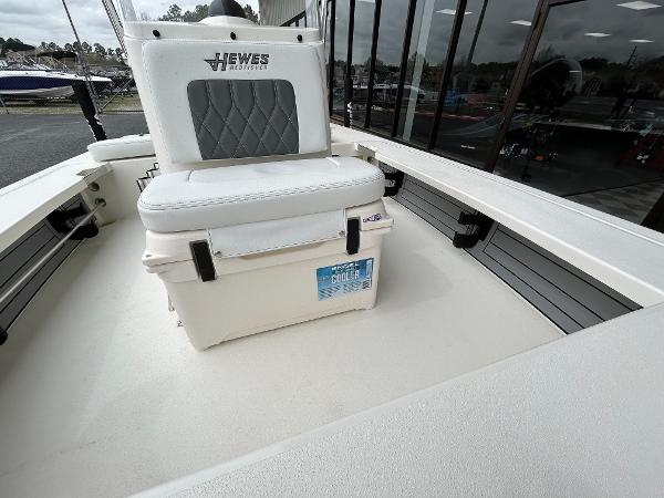 Slide: The Image of 2024 Hewes Redfisher 18 boat interior with cushioned seat and cooler. - 25