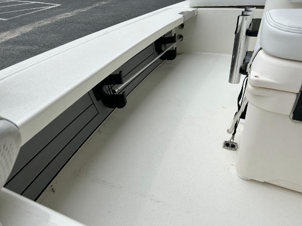 Slide: The Image of 2024 Hewes Redfisher 18 boat interior, featuring rod holders and seating. - 26