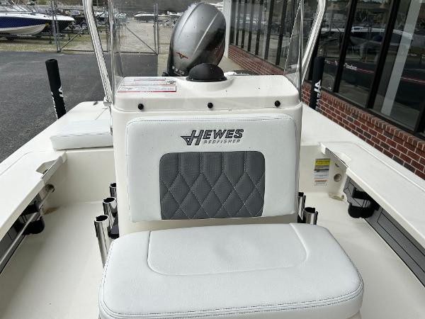 Slide: The Image of 2024 Hewes Redfisher 18 boat interior with cushioned seating and console. - 27
