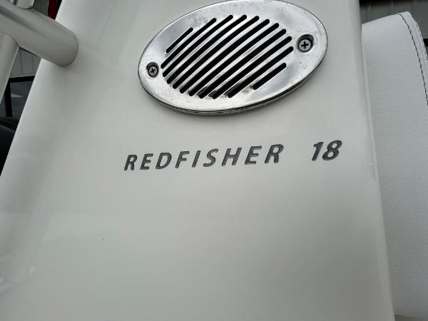 Slide: The Image of 2024 Hewes Redfisher 18 boat model nameplate and speaker detail. - 8