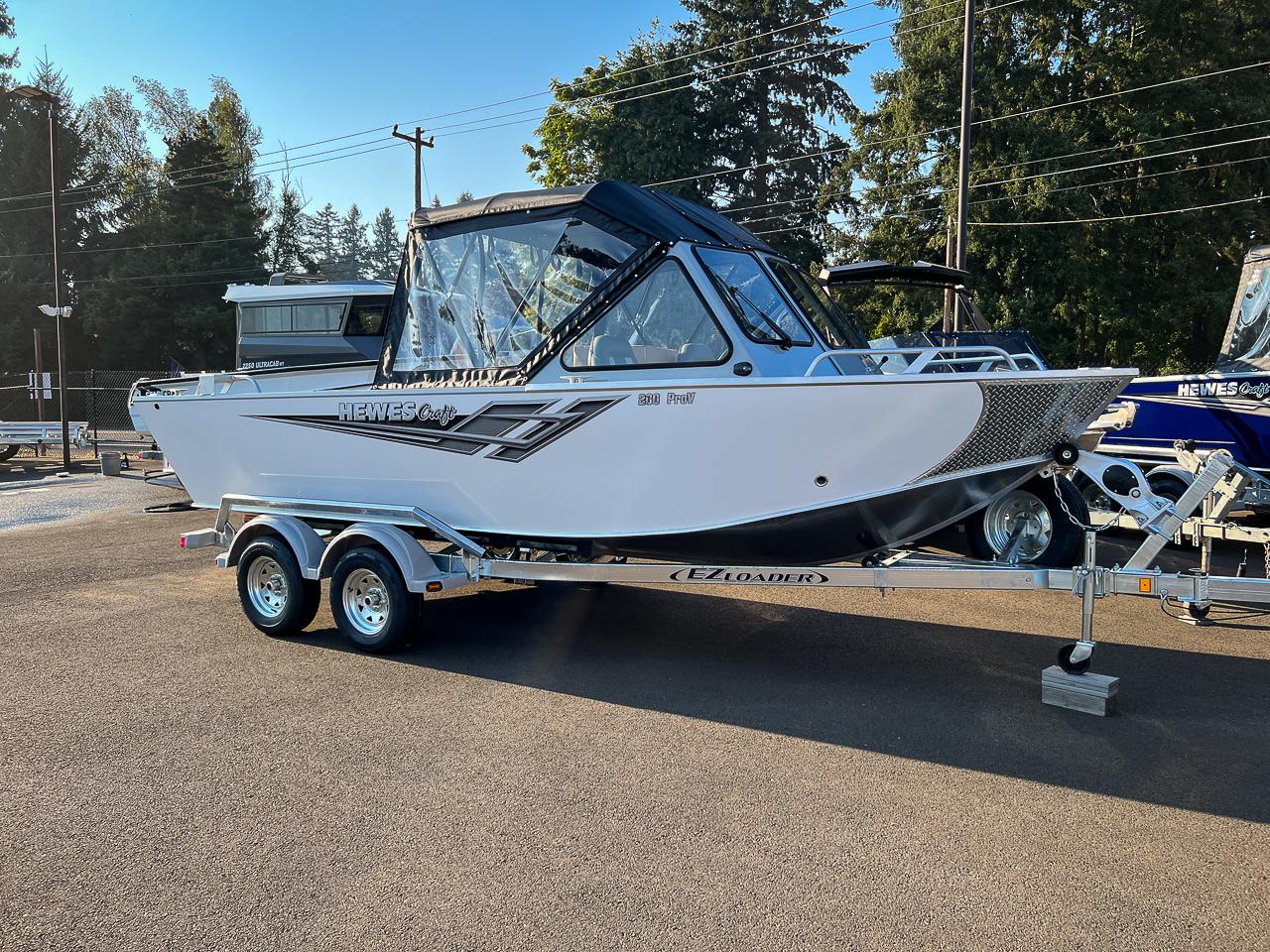 Slide: The Image of 2024 Hewescraft 200 Pro-V boat on EZ Loader trailer in parking lot. - 1