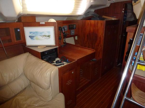 Slide: The Image of Interior of a 2001 Hunter 420 Passage sailboat with wooden cabinetry and beige seating. - 22