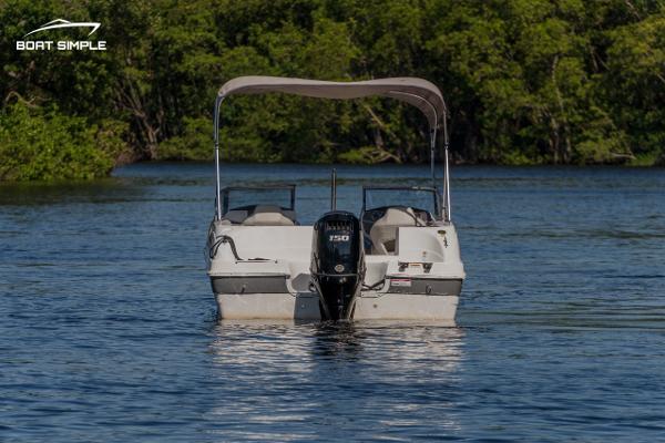 Slide: The Image of 2022 Hurricane 217 SD boat on calm water with canopy. - 3