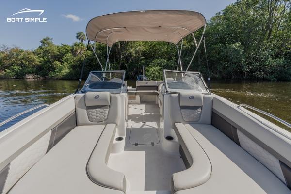Slide: The Image of 2022 Hurricane 217 SD boat with spacious seating and canopy on a calm river. - 9
