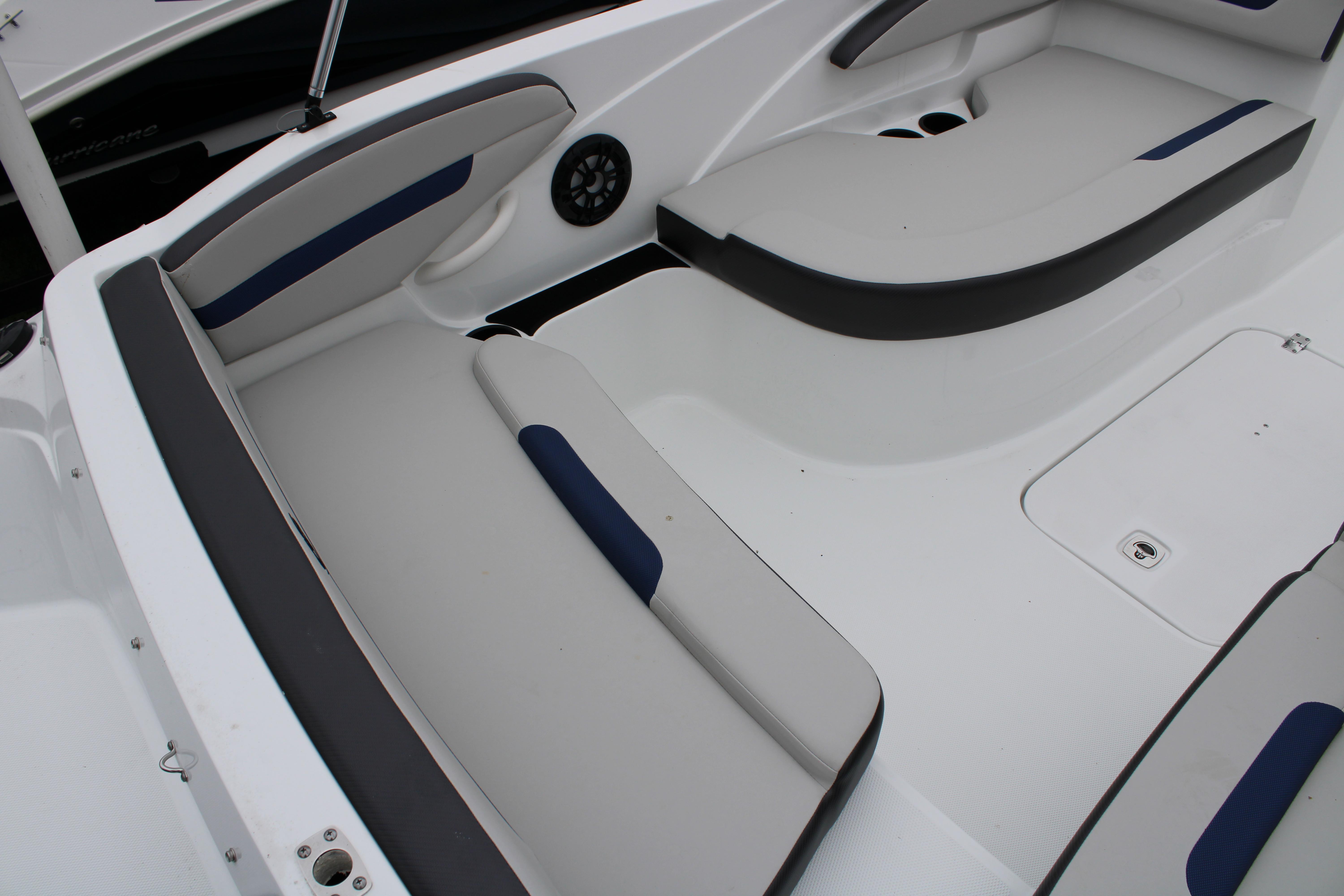 Slide: The Image of Interior seating of 2023 Hurricane SunDeck Sport 205 OB boat with white and blue cushions. - 11