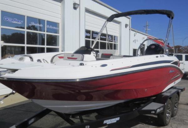 Slide: The Image of 2023 Hurricane SunDeck Sport 205 OB boat in red and white on a trailer. - 2