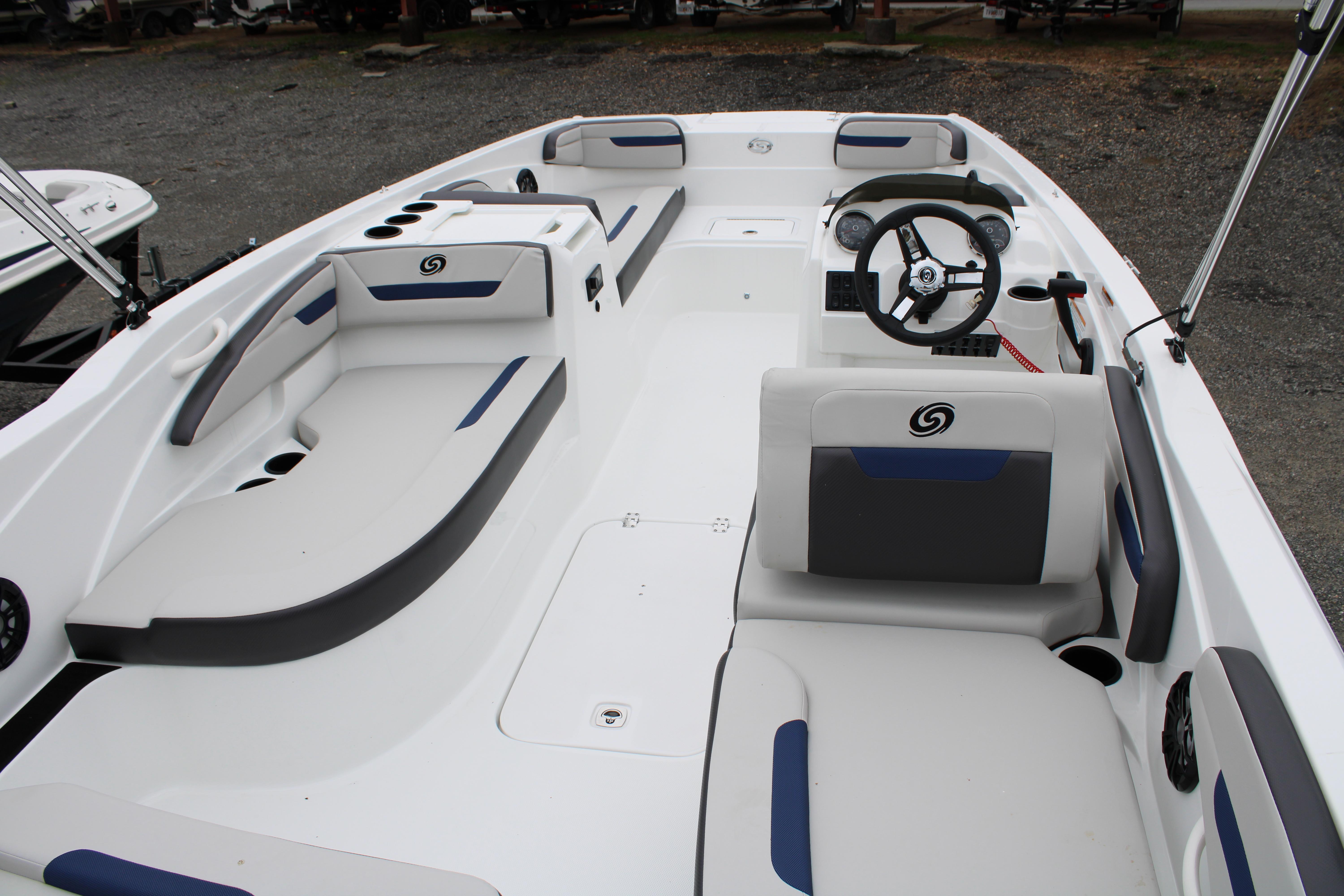 Slide: The Image of 2023 Hurricane SunDeck Sport 205 OB interior, spacious seating, modern design, and steering console. - 6