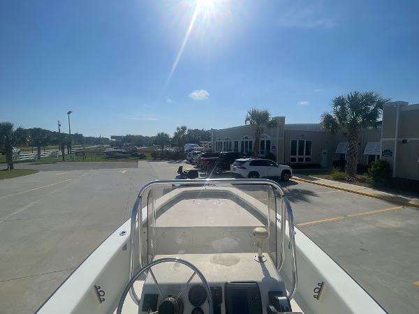 Slide: The Image of 2006 Intruder Pro Marine 20 boat parked in a sunny lot near buildings. - 5