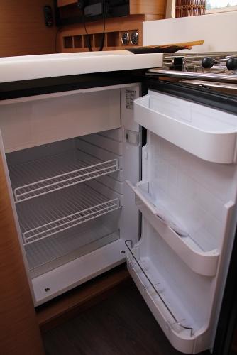 Slide: The Image of Open fridge inside 2025 Jeanneau Sun Odyssey 440 yacht kitchen. - 18