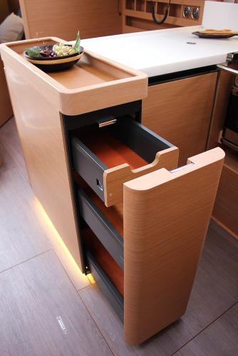 Slide: The Image of Modern kitchen drawer in 2025 Jeanneau Sun Odyssey 440 yacht, featuring sleek wooden design. - 19