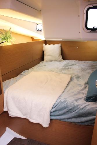Slide: The Image of Cozy cabin interior of 2025 Jeanneau Sun Odyssey 440 sailboat with bed and window. - 25