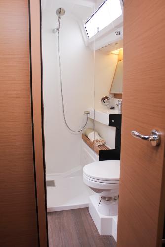 Slide: The Image of 2025 Jeanneau Sun Odyssey 440 bathroom with modern fixtures and wooden accents. - 26
