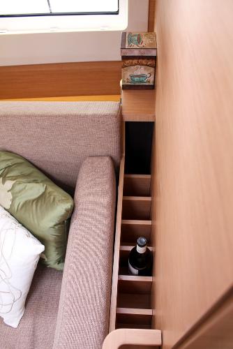 Slide: The Image of Interior of 2025 Jeanneau Sun Odyssey 440 with sofa and built-in bottle storage. - 37