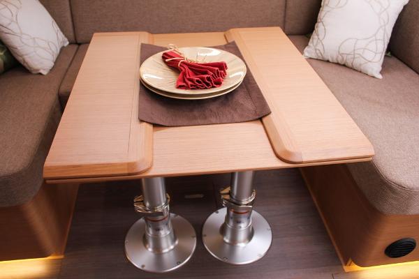 Slide: The Image of Interior of 2025 Jeanneau Sun Odyssey 440 yacht with elegant wooden table setting. - 46