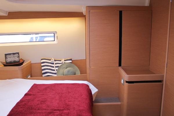 Slide: The Image of Interior cabin of 2025 Jeanneau Sun Odyssey 440 yacht, featuring modern wood finish. - 8