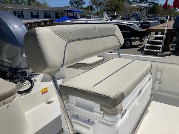 Slide: The Image of 2024 Key West 1720 Sportsman boat with cushioned seating and outboard motor. - 13