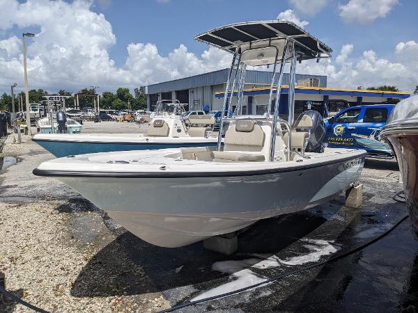 Slide: The Image of 2024 Key West 188 Bay Reef boat in a marina under a sunny sky. - 0