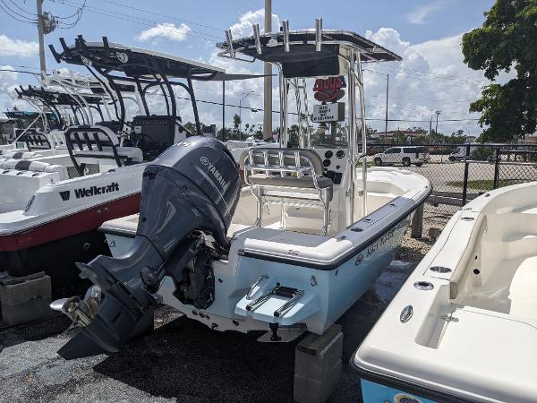 Slide: The Image of 2024 Key West 188 Bay Reef boat with Yamaha outboard motor in a marina. - 2