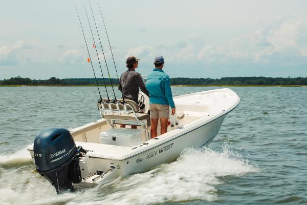 Slide: The Image of 2024 Key West 188 Bay Reef boat cruising on water with two people onboard. - 28