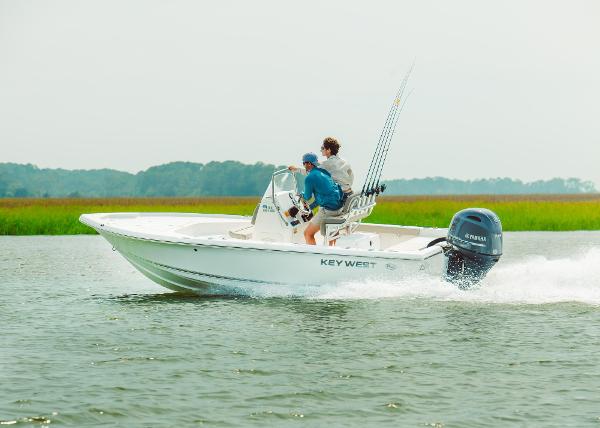 Slide: The Image of 2024 Key West 188 Bay Reef boat cruising on a lake with two passengers. - 34