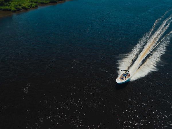 Slide: The Image of Aerial view of a 2024 Key West 189 FS boat cruising on a river. - 14