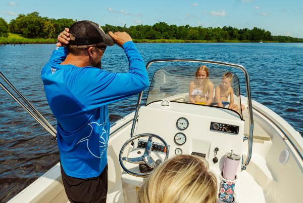 Slide: The Image of Family enjoying a ride on a 2024 Key West 189 FS boat on a sunny day. - 21