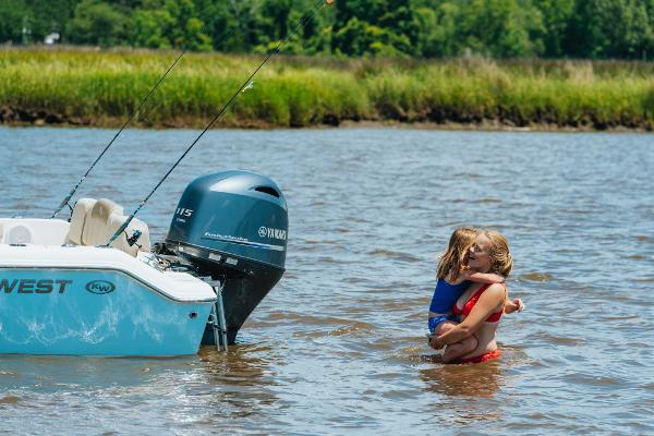 Slide: The Image of 2024 Key West 189 FS boat in shallow water with two children playing nearby. - 33