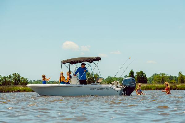 Slide: The Image of 2024 Key West 189 FS boat on water with people fishing and swimming. - 34